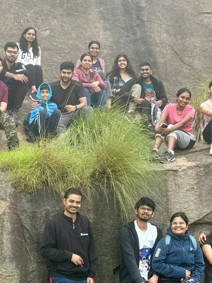 A group of trekkers relaxing on a rocky slope. Our trips have a perfect balance of challenging climbs and relaxed moments.