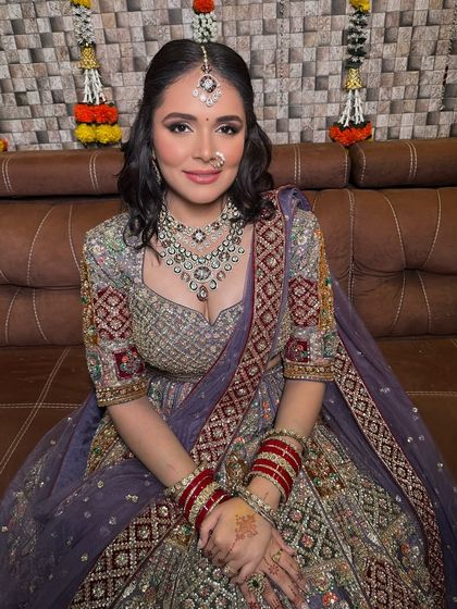 A real bride in a unique lavender-grey lehenga with multi-colored threadwork. This is a perfect example of the distinctive rental pieces I offer.