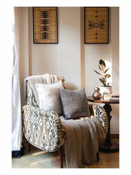 We introduce intimate, warm corners in obscure spaces of the villa. This cozy armchair, with its ikat-patterned upholstery and plush cushions, creates a perfect reading nook bathed in natural sunlight. It’s these small moments that make a house feel like a home.