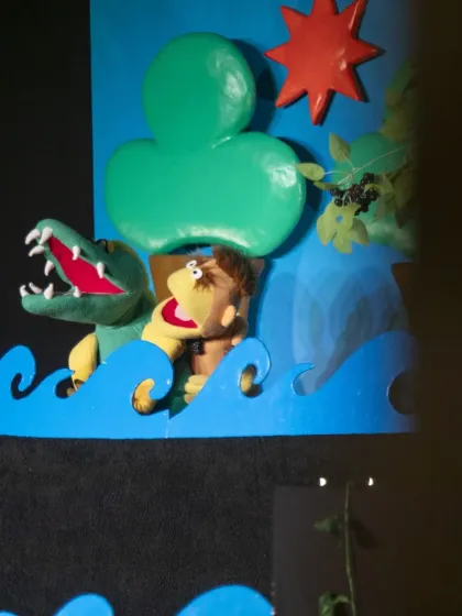 A close-up of the action in 'The Monkey & The Crocodile'. The colourful hand puppets and bright scenery make this Indian folktale accessible and fun for young children.