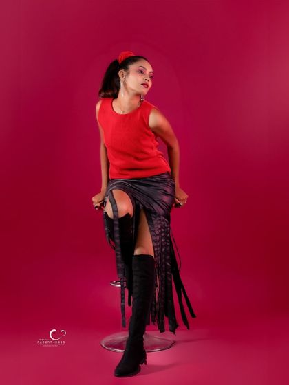 A thoughtful and elegant pose on the stool. The composition is artistic and full of grace.