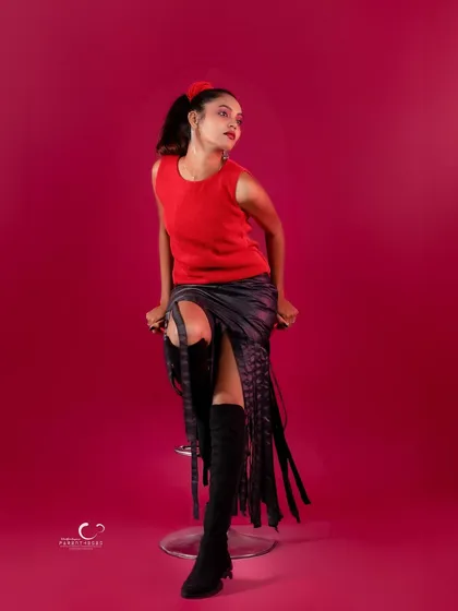 A thoughtful and elegant pose on the stool. The composition is artistic and full of grace.