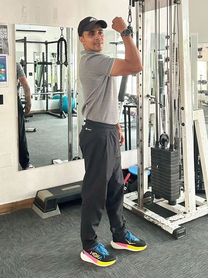 A side view of a bicep flex, showcasing the results of dedicated strength training.