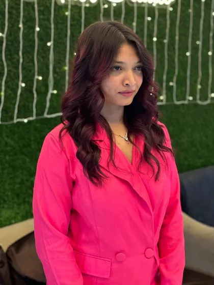 A bold and beautiful transformation. This client's new style features a deep magenta color with soft curls, showing how color can completely change your vibe.