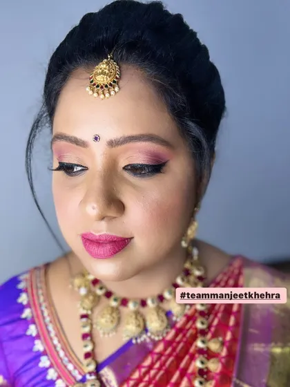Attending her brother-in-law's Muhurtham, this client looked so pretty in a traditional silk saree. I created a soft makeup look with pink-toned eyeshadow and a matching lip to complement her temple jewellery.