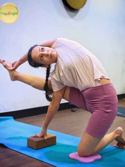 Advanced poses like Vishwamitrasana require significant strength and flexibility. Here, we use props like a block and knee pad to modify the pose, making it more accessible while still building toward the full expression.