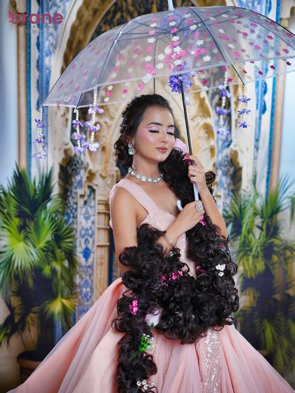 The umbrella prop frames the model beautifully, creating a whimsical and enchanting portrait.