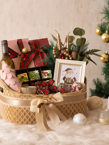 Our Christmas Feast Hamper is the ultimate festive indulgence. It's a huge basket filled with everything from wine and coated strawberries to brownies, cookies, and chocolate bombs.