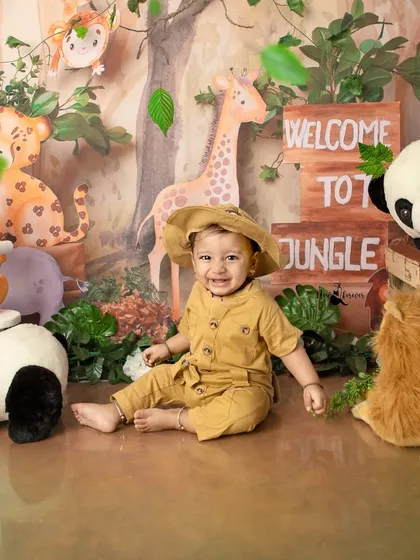 Surrounded by his jungle friends, this little explorer is the star of the show. The setup is filled with cute animals and lush greenery.