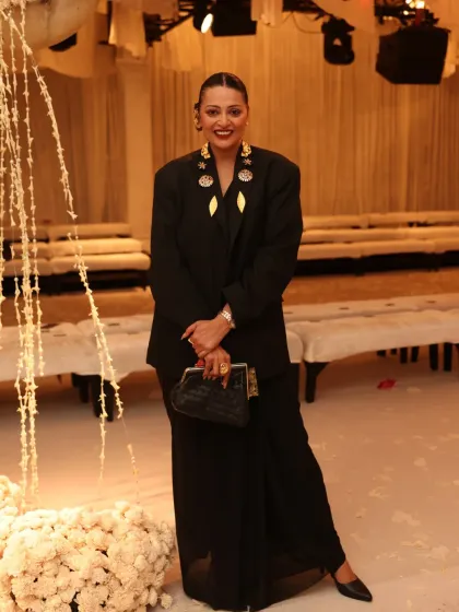Fusion styling is about breaking the rules with confidence. For India Couture Week, I layered a sharp, oversized black blazer over a simple black saree. The look is elevated with statement gold ear cuffs and brooches, transforming a classic ensemble into a high-fashion statement that is both powerful and chic.