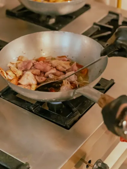 Stir-frying fresh ingredients in the wok. You can see the care we put into each step of the cooking process.