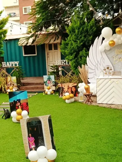 A closer look at the personalized photo gallery walkway for a birthday party. Each photo stand is decorated with a small balloon cluster, adding a festive touch to the sentimental journey.