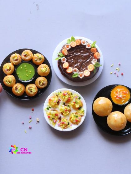 A delicious spread of my favorite street food miniatures: pani puri, dahi puri, and chole bhature, alongside a chocolate cake.