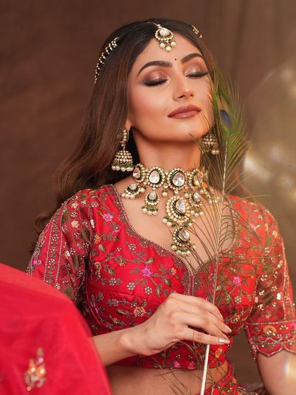 An artistic shot with a peacock feather, adding a touch of traditional symbolism to the modern look.