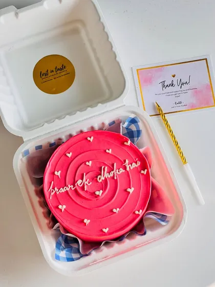 Say it with a cake, no matter how cheeky the message. This vibrant pink bento with the message "pyaar ek dhoka hai" shows how we can have fun with custom text for any occasion.