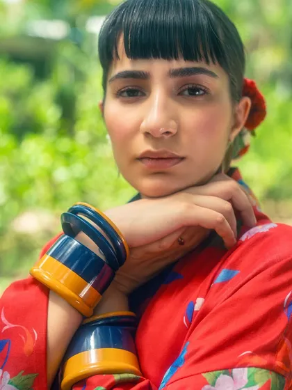 A close-up from my red kimono look, focusing on the bold, colorful bangles and soft makeup.