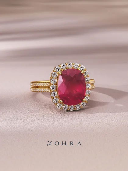 Custom-made, just like your sparkle. This stunning ring features a large, cushion-cut ruby surrounded by a halo of diamonds, set on a split-shank pavé band. The 18k gold setting enhances the ruby's fire, reflecting a heart full of light.