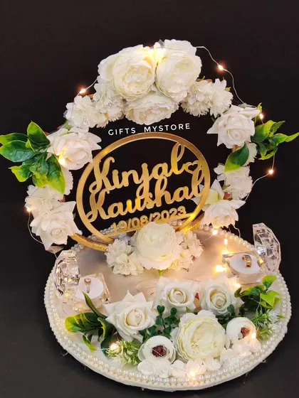 A touch of class for your engagement bliss. This exquisite all-white ring platter for Kinjal and Kaushal is lit with fairy lights.