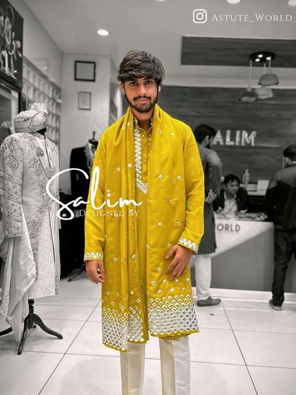A client in a bright yellow kurta with intricate white mirror work embroidery at the bottom. The matching stole completes this vibrant and festive look.