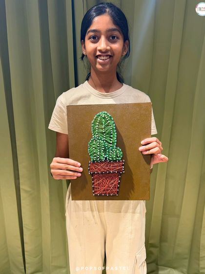 A sharp and prickly cactus made from soft string. This young artist did a fantastic job creating her unique piece of decor.