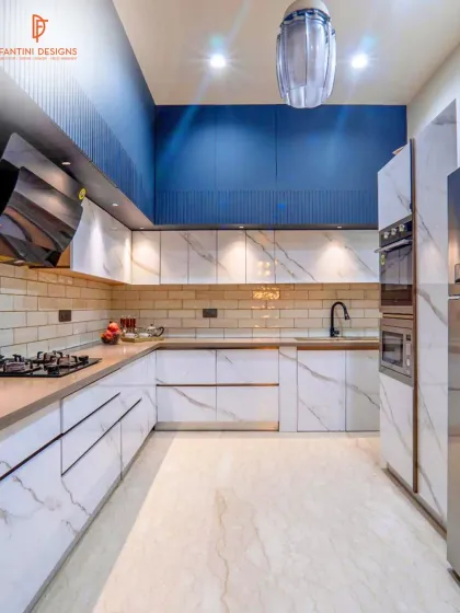 Another angle of the blue and white kitchen, showing the built-in ovens and the ample counter space, designed for both style and serious cooking.