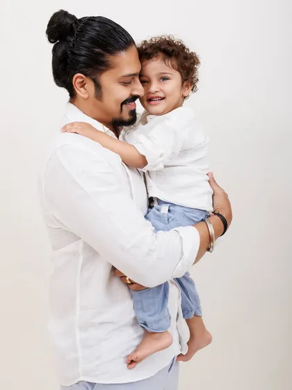 A father and son share a happy moment. The genuine connection and joy are what make family portraits so special.