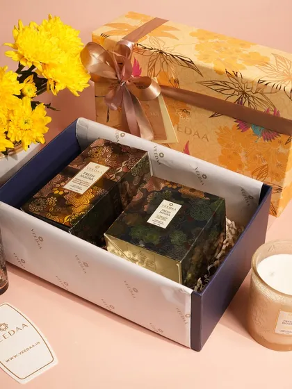 An open view of one of our curated gift sets, showcasing how we carefully arrange each item. This yellow-themed hamper includes candles and room sprays, presented with tissue paper for a premium unboxing.