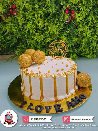 A luxurious white and gold drip cake. Decorated with golden spheres and edible gold leaf, this cake is perfect for celebrating any special moment in style.