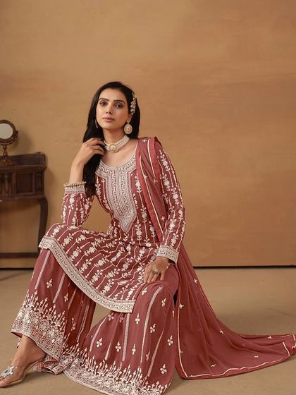 This chocolate-colored salwar kameez is rich and elegant. The all-over thread embroidery on the georgette fabric gives it a classic, timeless appeal.