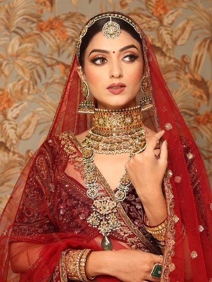Another angle of the royal bride, showcasing the intricate details of her makeup and matha patti.