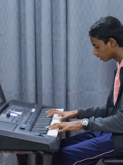 A photo of a student playing the keyboard at our BEML branch.