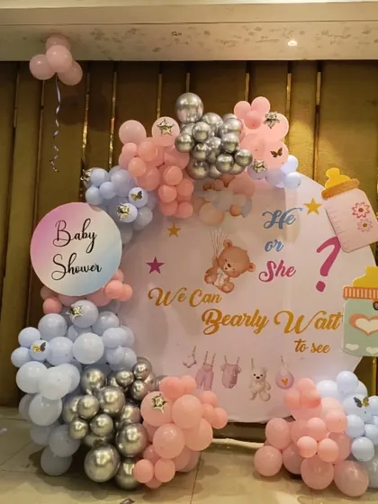 This "We Can Bearly Wait" theme is perfect for a sweet gender reveal or baby shower. The design features a circular backdrop with cute graphics, surrounded by a pastel pink, blue, and silver balloon arch with adorable themed cutouts.