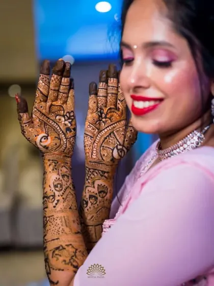 A candid shot of the bride, her beautiful mehndi framing her smiling face. The joy of the occasion is perfectly captured here.