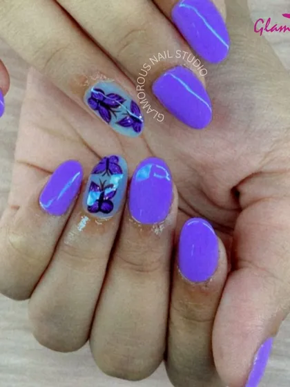 Vibrant purple nails are paired with sheer accent nails featuring beautifully detailed, hand-painted purple butterflies.