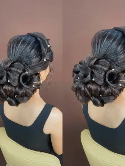 A stunning and intricate rose bun, a very advanced style that looks like a blooming flower.