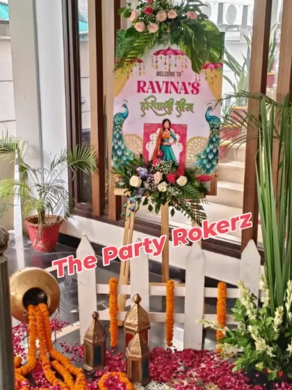 A personalized welcome easel for a Teej party, decorated with fresh flowers and featuring a custom graphic for the host.