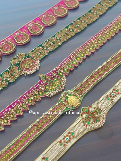 A closer look at the craftsmanship, highlighting a belt with a Lakshmi kasu coin, another with peacock motifs, and a classic kemp stone design.