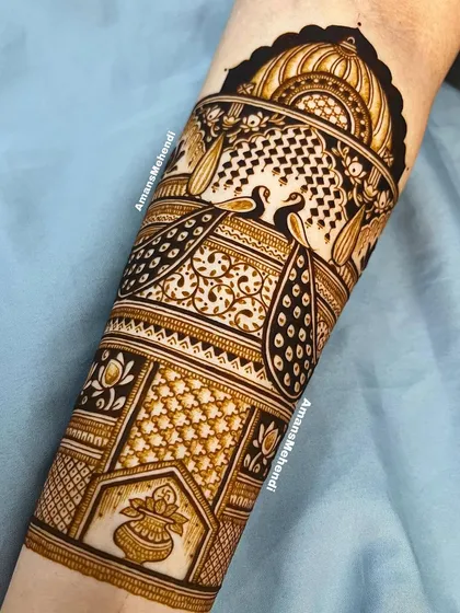 A detailed view of a bridal arm piece. This section features multiple bands of peacocks, swans, and a kalash, all rendered with incredible precision.