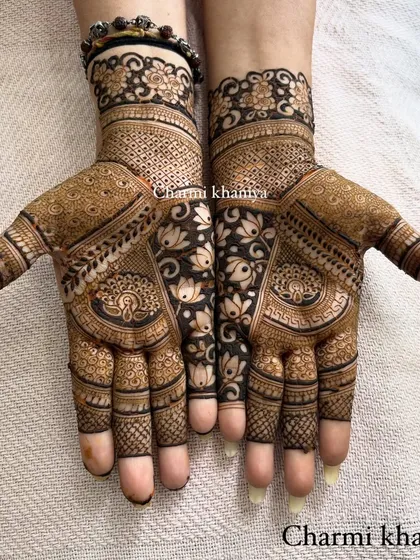A gorgeous full-hand design that combines the beauty of lotus flowers with the grace of peacocks. The negative space created by the central vine makes the whole pattern pop.