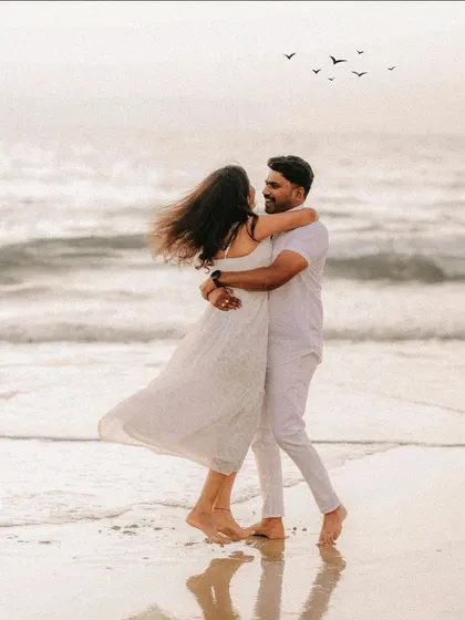 There's a beautiful freedom in this shot. The couple, lost in their own world on a breezy beach, showcases the fun and carefree side of love. It’s a perfect example of how I use natural elements like the sea and wind to tell your story.