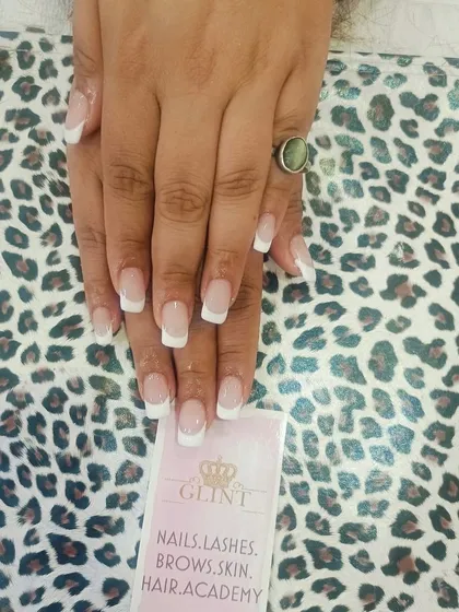 The quintessential classic French manicure. This look features perfectly shaped square nails with a natural pink base and crisp, clean white tips for a timeless and polished appearance.