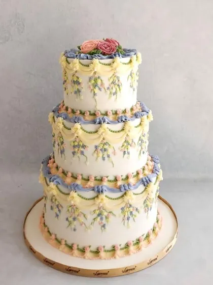 I just love the classic beauty of English piping. This three-tiered wedding cake was a recent creation, featuring delicate buttercream swags and hand-piped floral details. It’s a timeless technique that I teach in my advanced workshops.