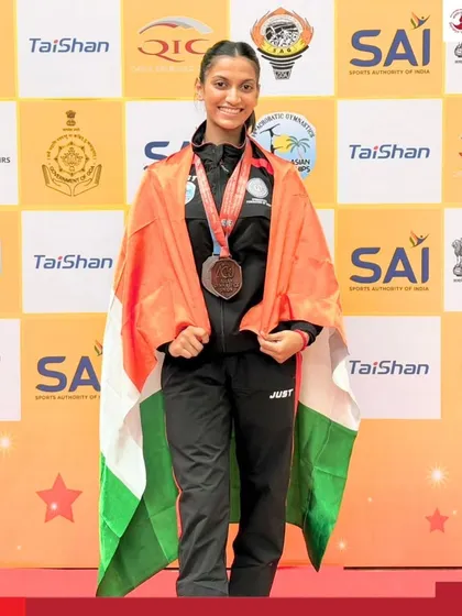 Representing India with grace and strength. Our gymnast Arna Patil stands on the podium draped in the Indian flag after winning medals at the 14th Acrobatic Gymnastics Asian Championships.