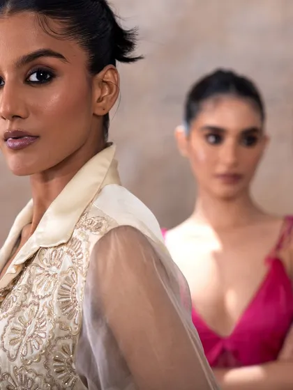 This image captures a moment between two models, one in focus with a sharp, defined eye. It demonstrates my ability to create layered compositions where the makeup enhances the narrative of the photograph.