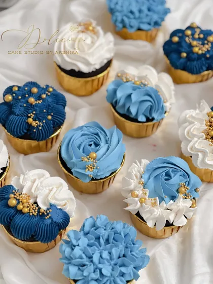 A look at some of my custom cupcakes. I used different piping techniques to create a variety of floral designs in shades of blue and white, finished with a sprinkle of gold. These are perfect for matching a party's color scheme.