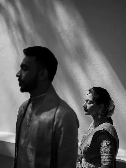 An artistic black and white portrait capturing a moment of quiet contemplation. We use light and shadow to create dramatic, soulful images that add a layer of depth and artistry to your wedding film.