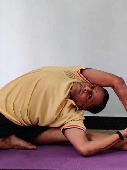 Parivrtta Janu Shirshasana (Revolved Head-to-Knee Pose). A seated pose that combines a forward bend with a deep lateral stretch and twist.