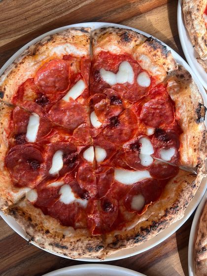 A beautiful shot of our Nduja & Soppressata pizza, with its vibrant red colours and perfectly melted cheese.