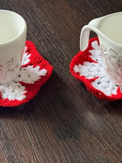 A pair of my snowflake-themed coasters in classic red and white. They are perfect for serving warm drinks during the cold Christmas season.