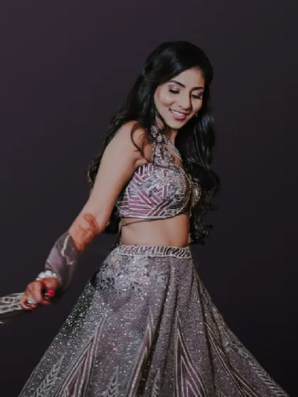 A beautiful shot of the bride twirling in her unique grey lehenga. The soft, flowing hair and glowing makeup complete this stunning Sangeet look.